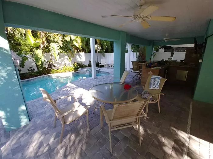 outdoor kitchen and pool area beachy villa vista vacation rental anna maria island florida