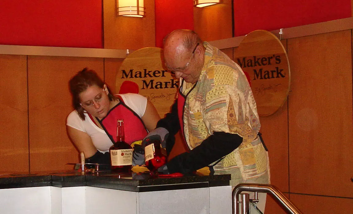 Dipping bottles in wax on the Maker's Mark Distillery Tour 