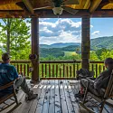 guys relaxing on the porch of a smoky mountains cabin rental