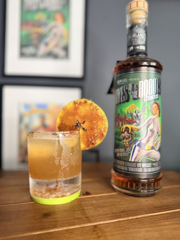 Caramelized Apple Rye Fest cocktail with a bottle of Filmland Spirits rye