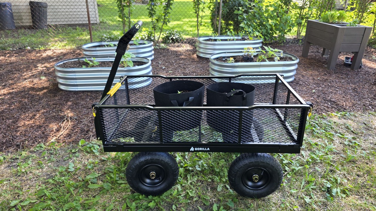 Gorilla GCG-1200 steel utility cart with grow bags in a backyard vegetable garden