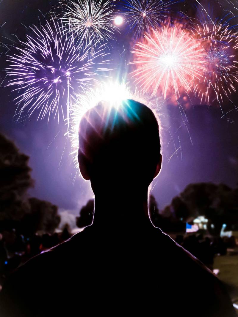 man watching at home fireworks display