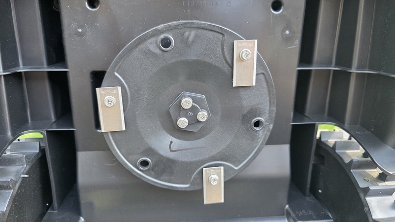 Underside of LawnMaster OcuMow R1600 cutting deck showing three pivoting razor blades on a rotating metal disc