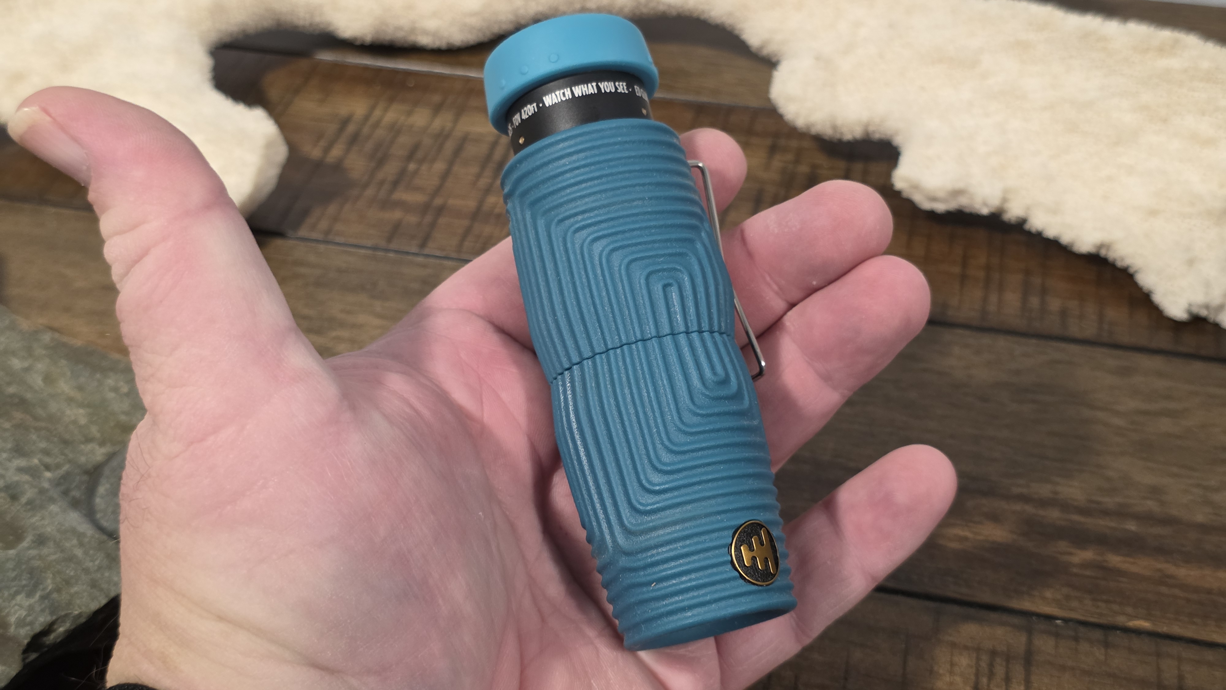 Nocs Provisions Zero Tube 8x25 monocular in blue Wave Armor held in one hand