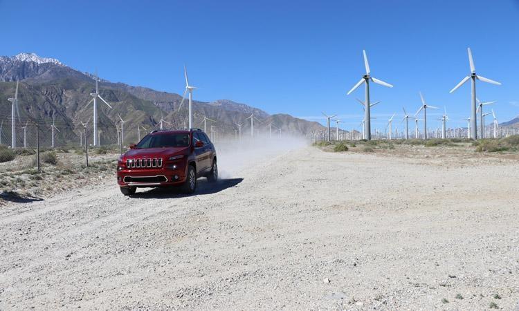 jeep cherokee driving past windmills in palm springs
