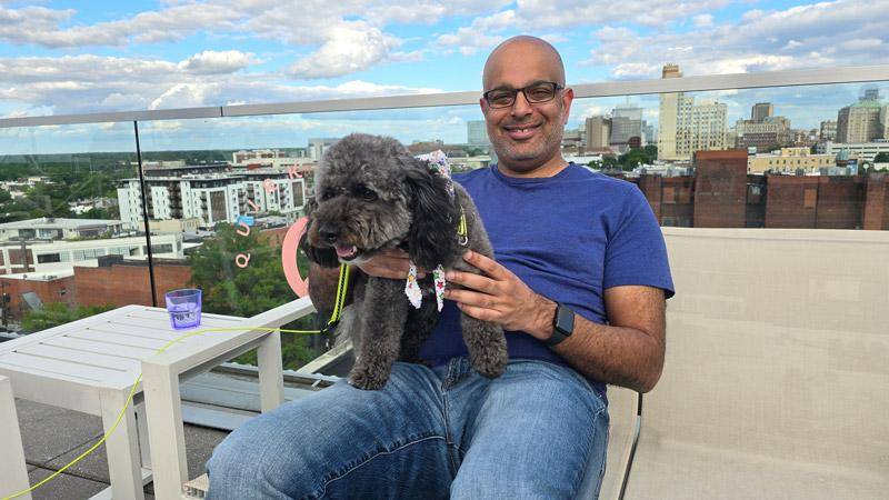 sujeet holding dog on rooftop at quirk