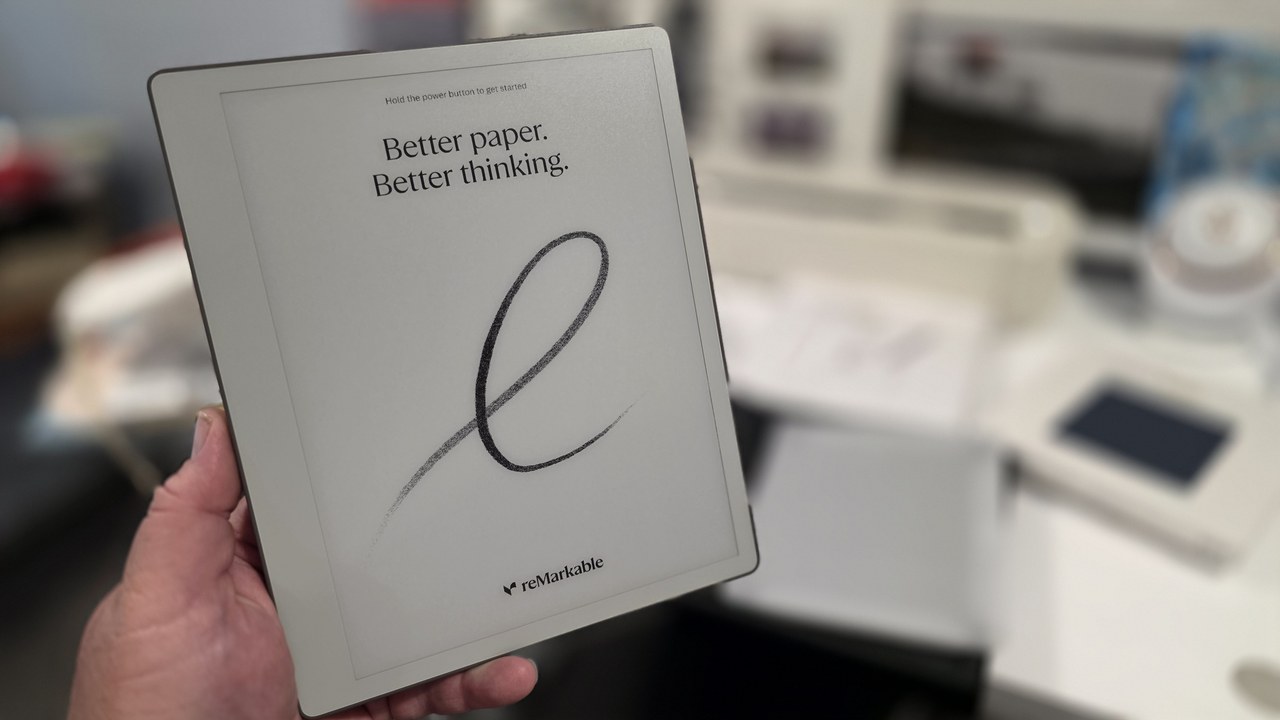 Holding the reMarkable Paper Pure showing the Better paper. Better thinking. welcome screen