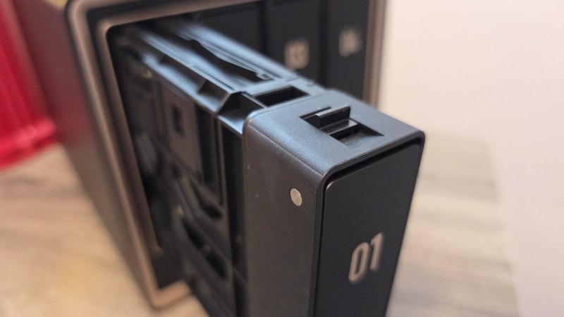 Close up of the drive caddy in bay 01 of the UGREEN NASync DXP4800 GT partially removed