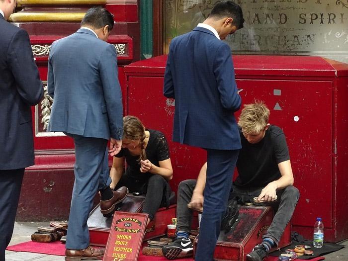 businessmen in london getting shoe shine