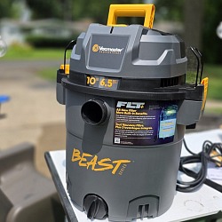 The Vacmaster Beast Series FLT+ 10-gallon wet dry vac set up outside on a work table